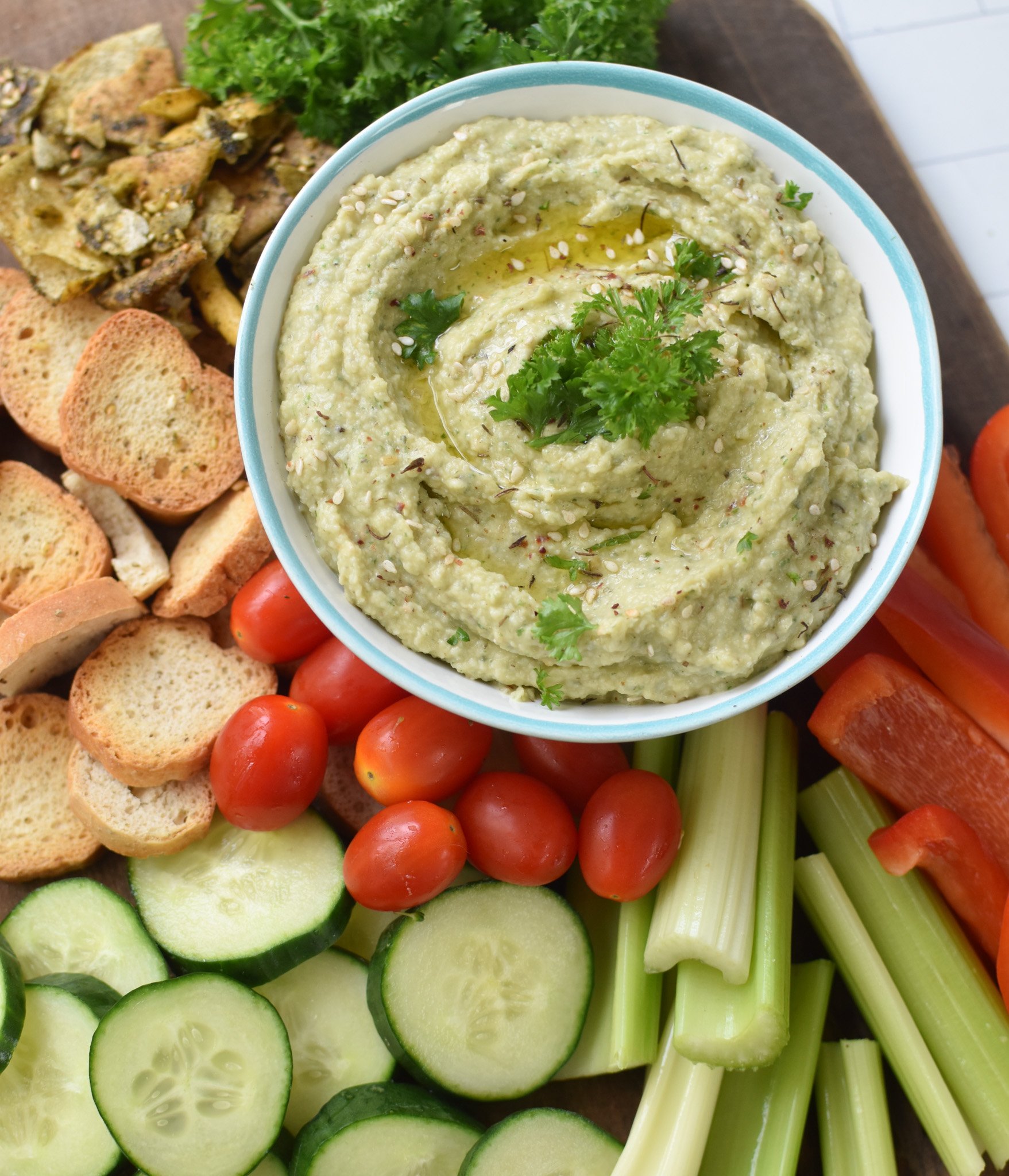 White Bean Artichoke Dip on a platter with vegetables. 