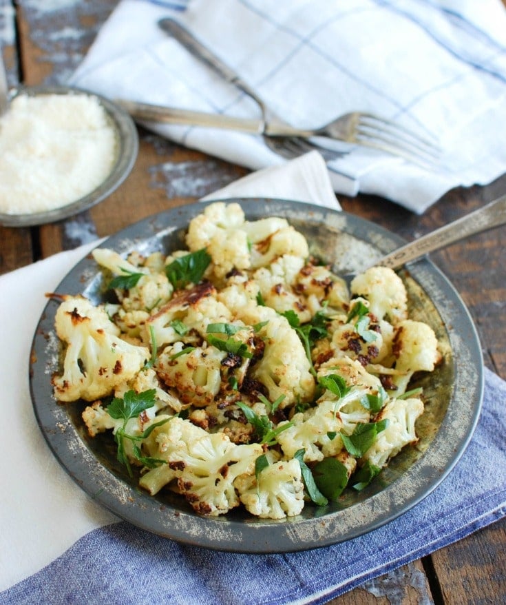 Roasted Parmesan Garlic Cauliflower is bursting with flavor. Add this delicious side dish to your rotation, the family will love it! 
