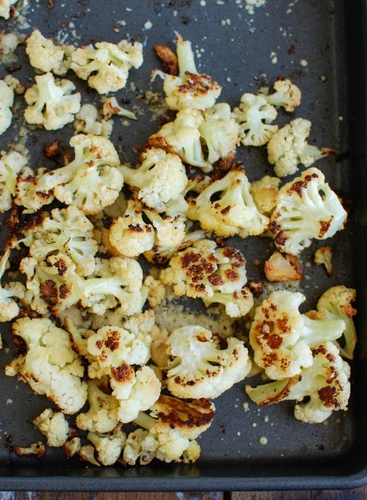 Roasted Parmesan Garlic Cauliflower is a new way to eat cauliflower. Roasted cauliflower is sweet and pairs nicely with parmesan cheese and garlic. 