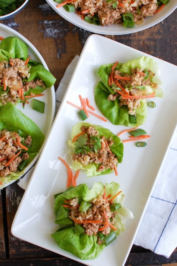 Asian Pork Lettuce Wraps are packed with your favorite Asian flavors and paired with ground pork, topped with cilantro and matchstick carrots and served in soft bibb lettuce wraps. These are light and the perfect easy meal! 