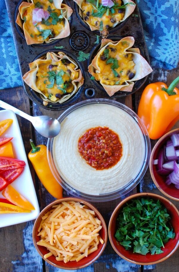 Southwestern Hummus Baked Wonton Cups are a fun finger food mixing spicy hummus, black beans, corn and cheese and baked into a wonton cup until crispy and warm. These are packed with flavor and work great as a snack or party food!