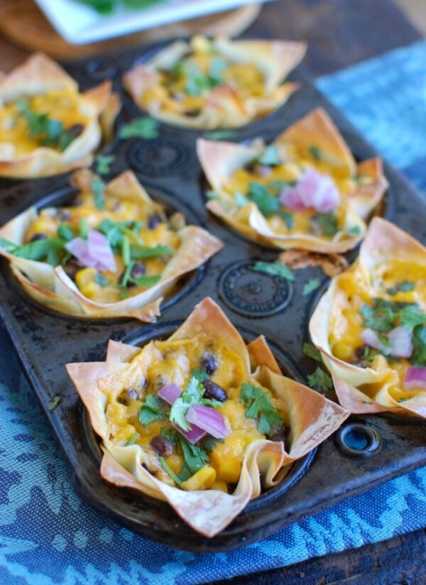 Southwestern Hummus Baked Wonton Cups are a fun finger food mixing spicy hummus, black beans, corn and cheese and baked into a wonton cup until crispy and warm. These are packed with flavor and work great as a snack or party food!