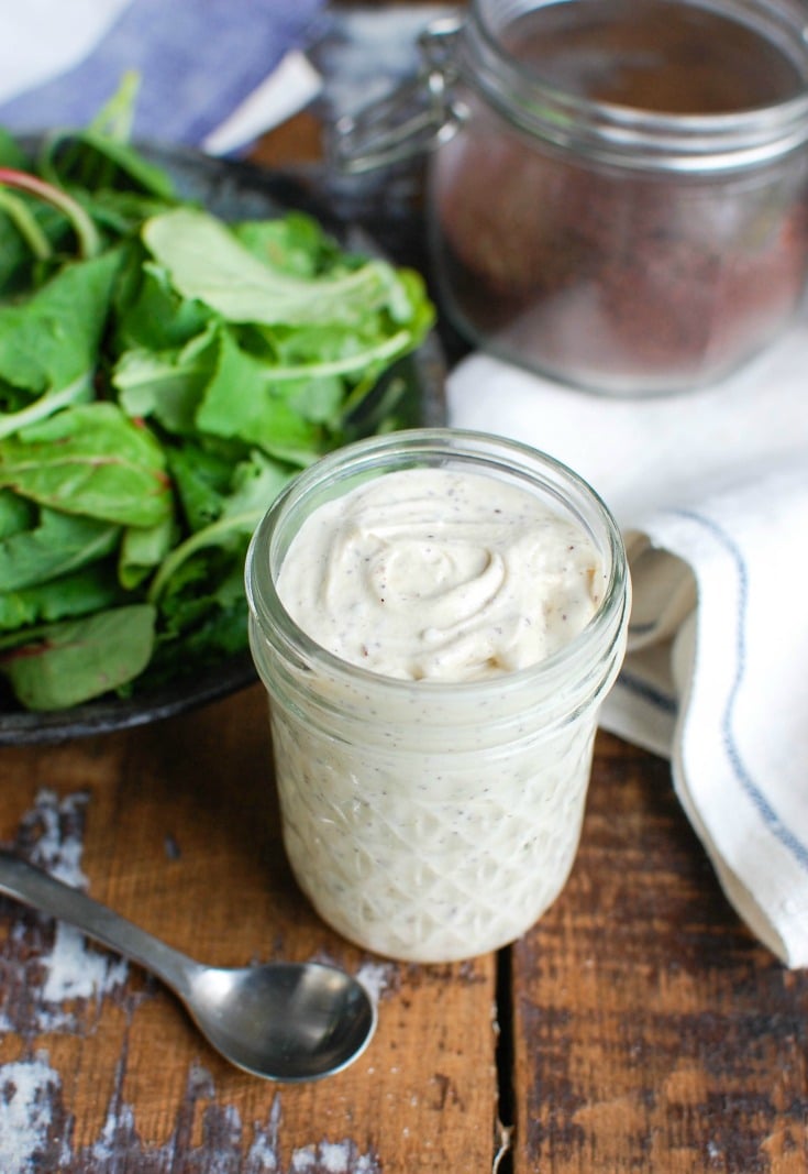 Tahini Yogurt Dressing in a jar with napkin