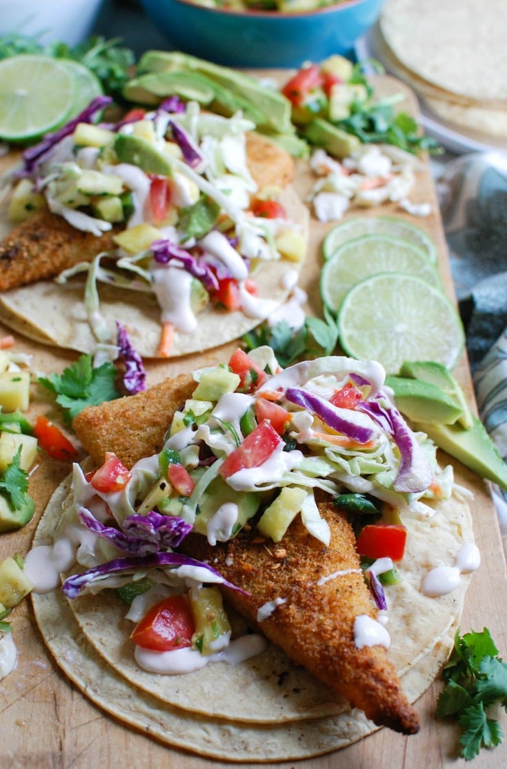 Easy Fish Tacos with Spicy Pineapple Salsa is a quick and easy meal that doesn't lack flavor! These are the perfect way to mix up taco night with baked breaded cod tacos topped with a spicy pineapple salsa and a spicy slaw.