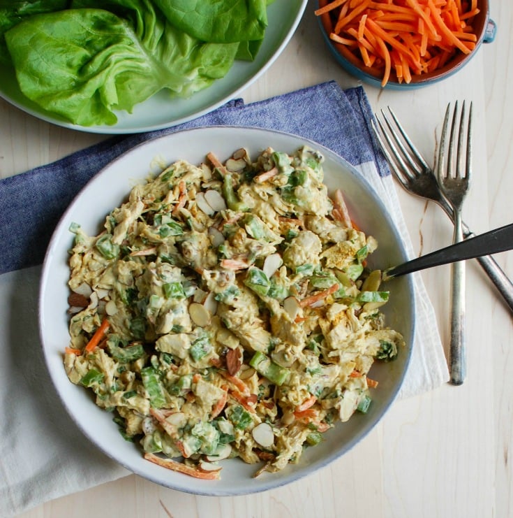 Simple Curry Chicken Salad is a lightened up version of classic chicken salad with rich, warm curry added in. Shredded chicken is mixed together with Greek yogurt, mayonnaise, honey and curry and then combined with golden raisins, shredded carrots, chopped celery, fresh green onion and parsley. This is a nice option for a picnic, weekly lunches or a shower or brunch!