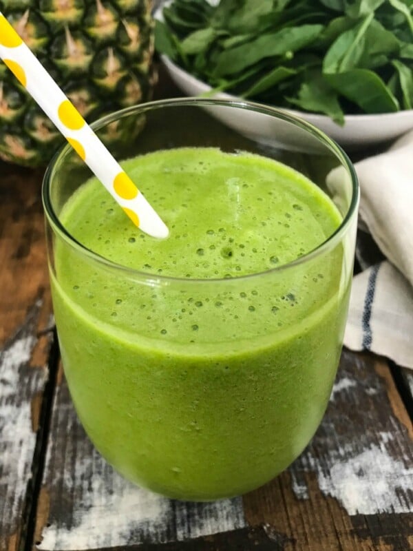This Tropical Green Smoothie is the perfect summer smoothie mixing a granny smith apple, fresh spinach, mint and frozen pineapple. You will get a good dose of your fruits and vegetables, while feeling refreshed on a hot summer day.