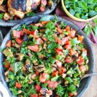 Mediterranean Eggplant Salad mixes grilled eggplant with fresh tomatoes, mint, parsley, green onion, bell pepper and tossed with olive oil, lemon juice, za'atar and crushed red pepper. This is the perfect side salad for a summer BBQ or party or to pair with grilled chicken or fish. 