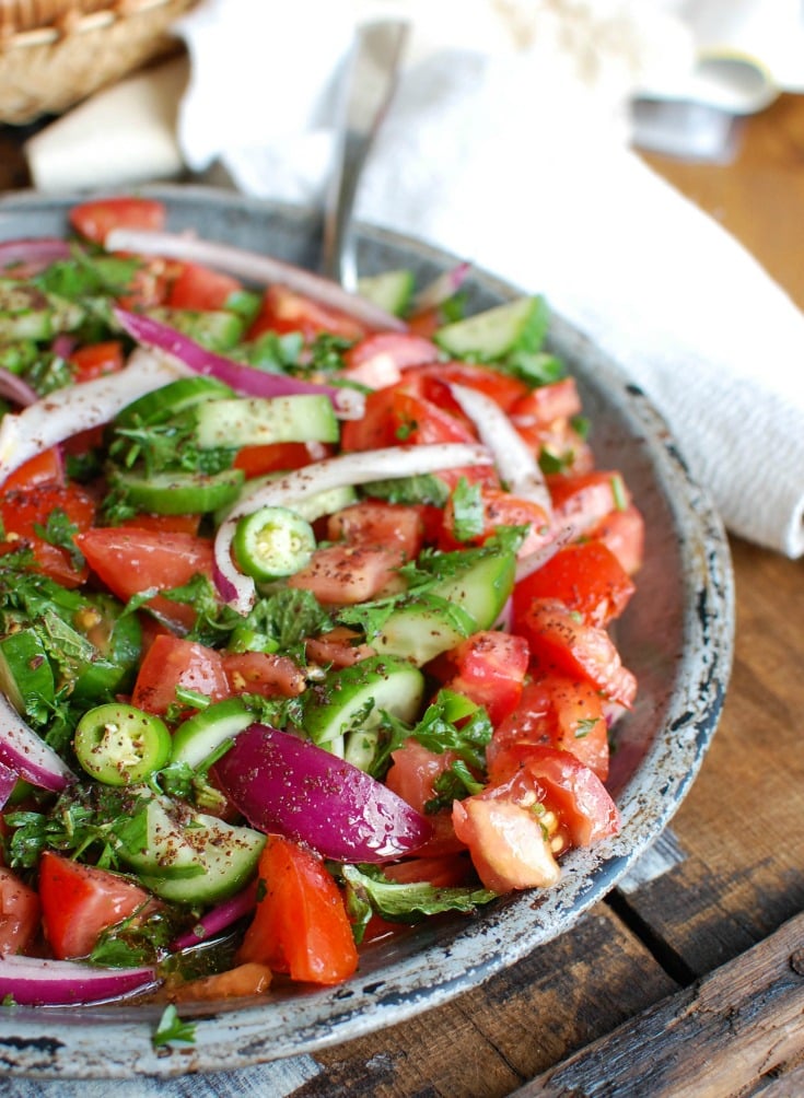 Persian Tomato Cucumber Salad is a fresh, light salad mixing tomatoes, cucumber, red onion, jalapeño, fresh mint and parsley and topped with an olive oil lemon dressing. This is the perfect side dish to any dinner or a nice lunch with some added chickpeas or grilled chicken. 