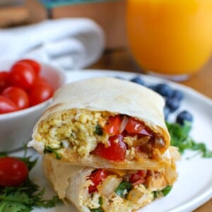 Vegetarian Breakfast Egg Burritos are a nice make-ahead breakfast for those busy days, especially during the school year. These breakfast burritos are loaded with veggies, eggs and cheese along with warm Southwestern spices. Make a big batch of these burritos and freeze them for later! 