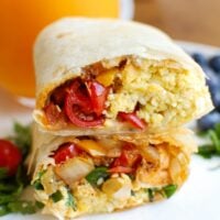 Vegetarian Breakfast Egg Burritos are a nice make-ahead breakfast for those busy days, especially during the school year. These breakfast burritos are loaded with veggies, eggs and cheese along with warm Southwestern spices. Make a big batch of these burritos and freeze them for later! 