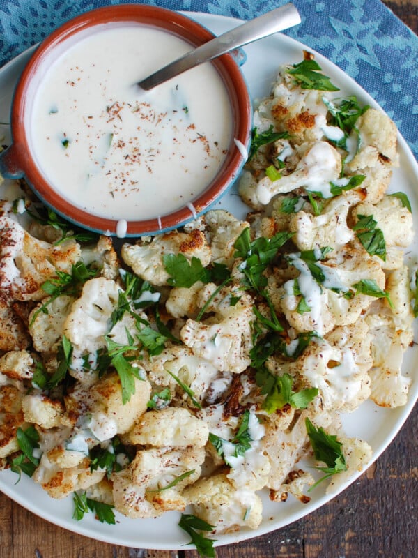 Za'atar Roasted Cauliflower with Yogurt Tahini Sauce takes your normal roasted cauliflower to a new level. Earthy and slightly sweet the za'atar is the perfect spice to add to your roasted cauliflower and is complimented nicely by the yogurt tahini sauce. 