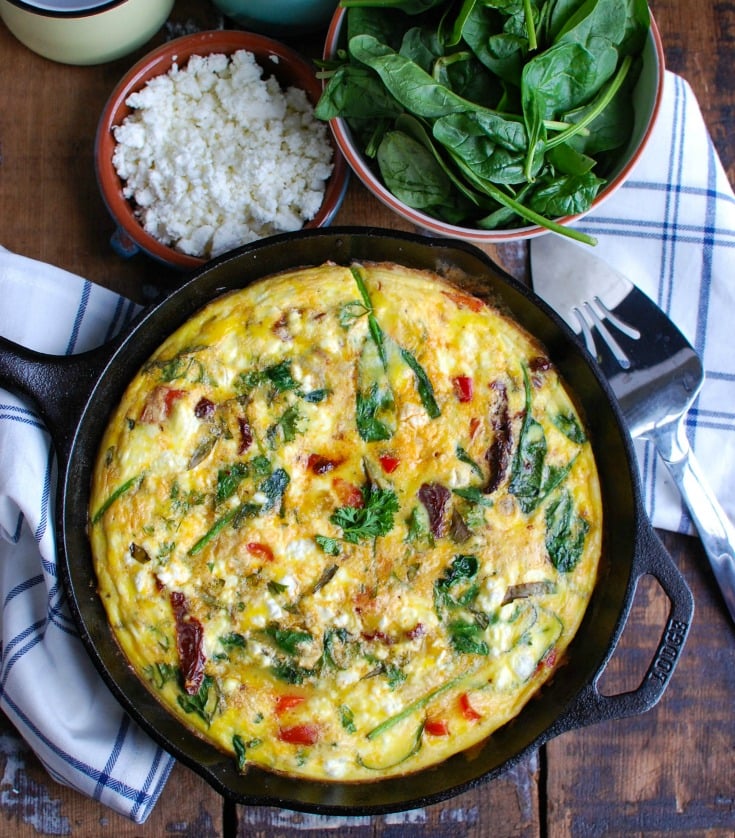 Sun-Dried Tomato Goat Cheese Frittata is a savory breakfast packed with healthy, filling ingredients. Sun-Dried tomatoes, spinach, red bell pepper, goat cheese and eggs are cooked and then baked to perfection. Serve this at a brunch or make it ahead of time for a quick weekday breakfast.