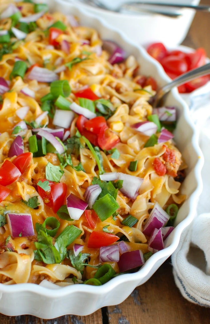 Easy Mexican Noodle Casserole makes weeknight meals easy, fun and festive with a colorful casserole packed with No Yolk Noodles,  colorful vegetables, ground turkey, spices and cheese. This dish will quickly become a family favorite. 