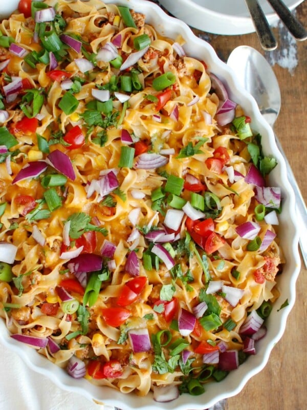 Easy Mexican Noodle Casserole makes weeknight meals easy, fun and festive with a colorful casserole packed with No Yolk Noodles,  colorful vegetables, ground turkey, spices and cheese. This dish will quickly become a family favorite. 
