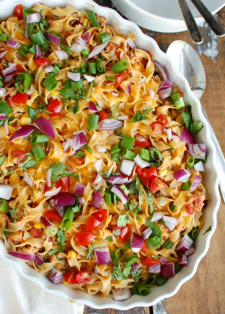 Easy Mexican Noodle Casserole makes weeknight meals easy, fun and festive with a colorful casserole packed with No Yolk Noodles,  colorful vegetables, ground turkey, spices and cheese. This dish will quickly become a family favorite. 
