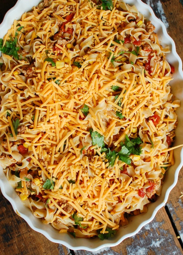 Easy Mexican Noodle Casserole makes weeknight meals easy, fun and festive with a colorful casserole packed with No Yolk Noodles,  colorful vegetables, ground turkey, spices and cheese. This dish will quickly become a family favorite. 