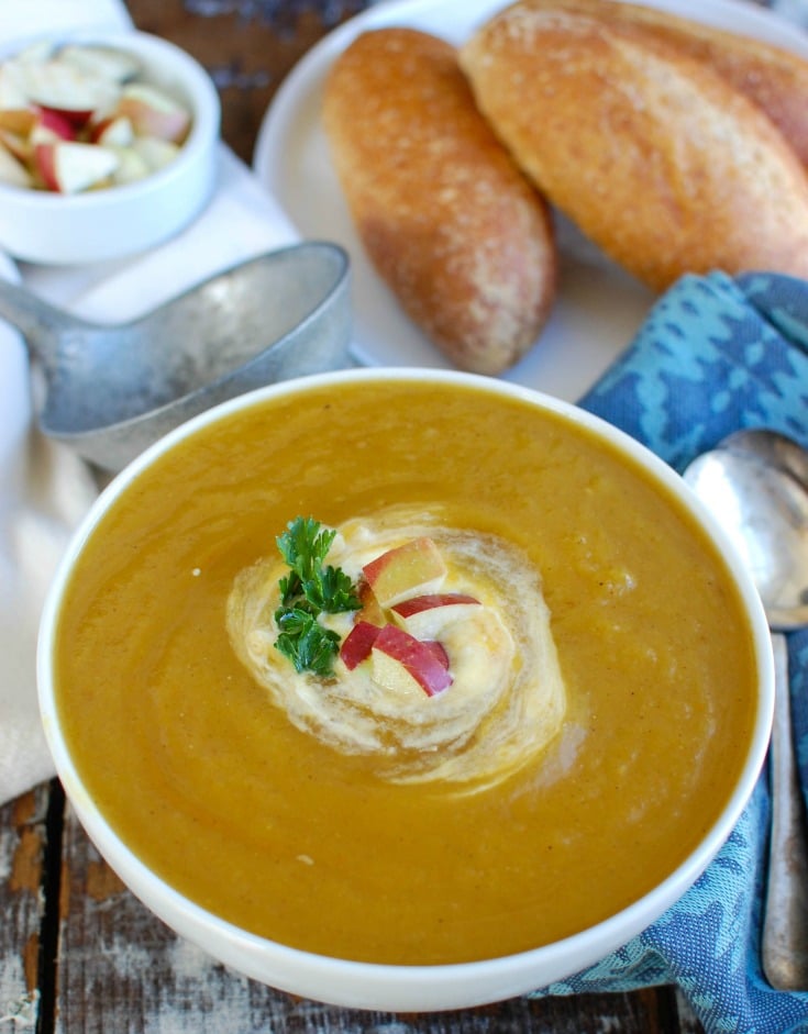 Slow Cooker Butternut Squash Apple Soup with parsley and cream.