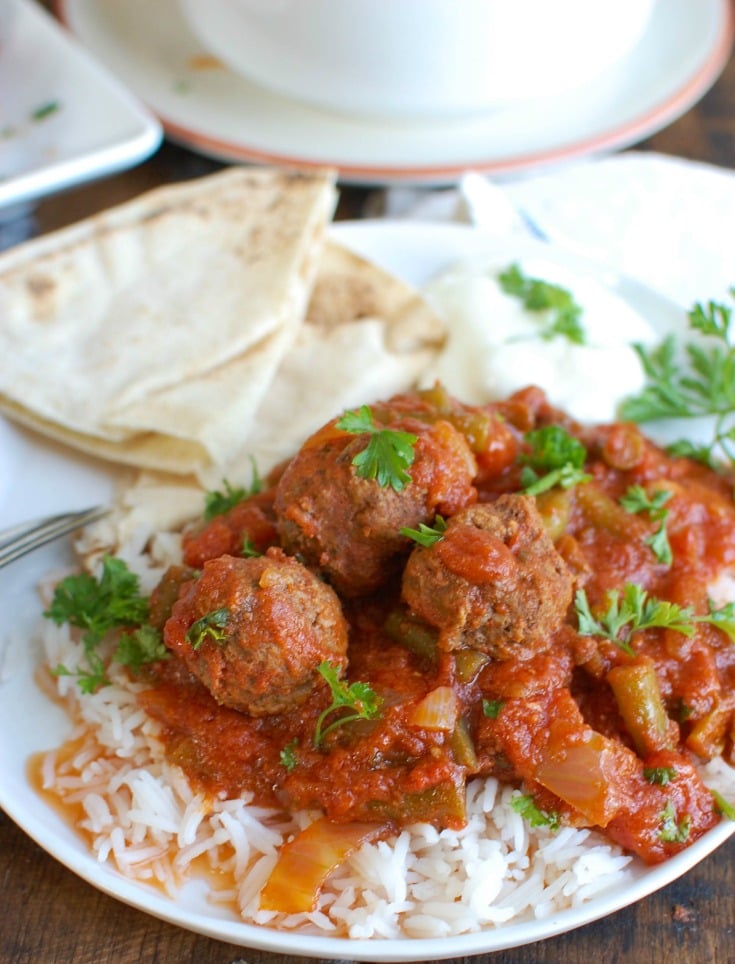 Slow Cooker Mediterranean Beef Meatballs with Lebanese Green Beans is full of warm spices and slow cooks in your crockpot to make dinner easy. Beef meatballs are spiced with Mediterranean flavors and slow cooker in Lebanese green beans creating the perfect sauce paired with the meatballs and rice.  