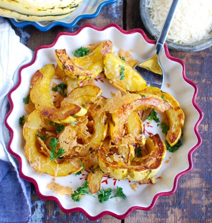 Roasted Parmesan Delicata Squash is sweet, savory and the perfect fall side dish. Delicata squash is roasted until soft and topped with parmesan cheese for the perfect flavor combination. This would also make a wonderful holiday side dish! 