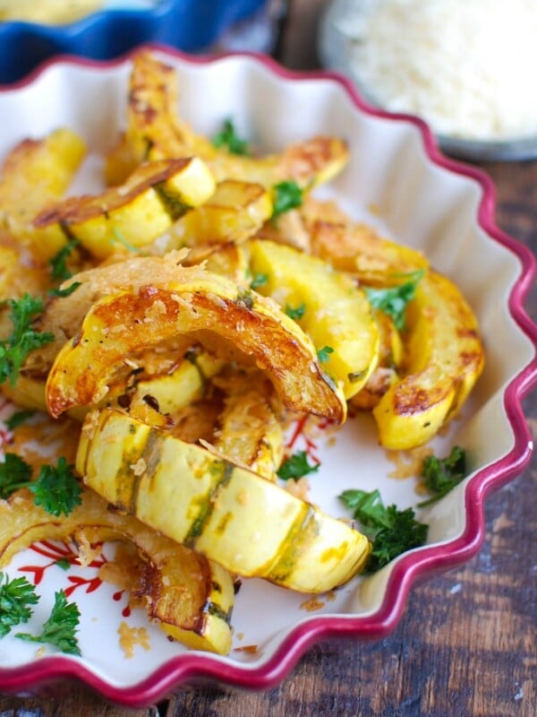 Roasted Parmesan Delicata Squash is sweet, savory and the perfect fall side dish. Delicata squash is roasted until soft and topped with parmesan cheese for the perfect flavor combination. This would also make a wonderful holiday side dish! 