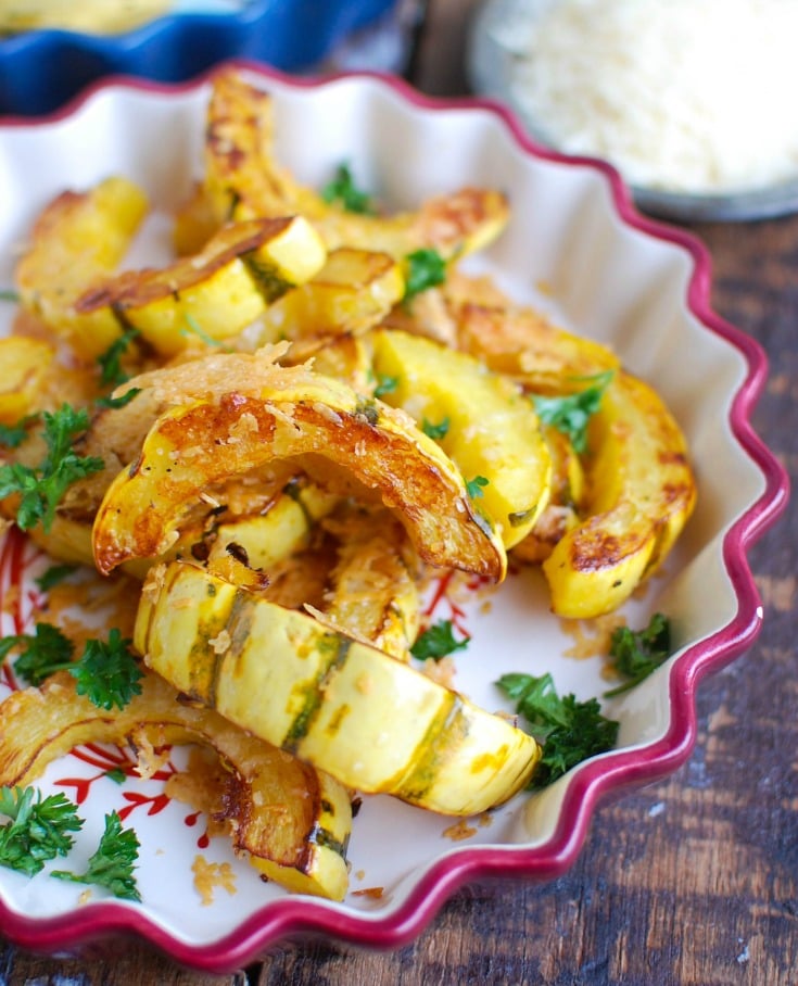 Roasted Parmesan Delicata Squash is sweet, savory and the perfect fall side dish. Delicata squash is roasted until soft and topped with parmesan cheese for the perfect flavor combination. This would also make a wonderful holiday side dish! 
