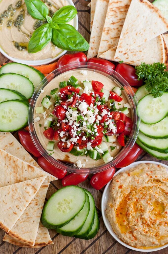 Snag a tub of your favorite hummus and whip up this Mediterranean Bruschetta Hummus topped with tomato, cucumber and feta.Hummus snack platter for a tasty pre-dinner nosh that's sure to satisfy!