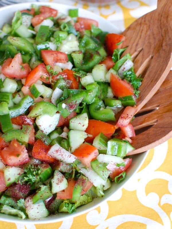 Easy Lebanese Salad, also known as Lebanese Salata, is a salad mixing chopped tomatoes, bell pepper, onion, cucumber, green onion and parsley topped with a lemony-mint dressing. This is healthy, light and the prefect addition to any meal or add grilled chicken or salmon to make it a meal itself. 