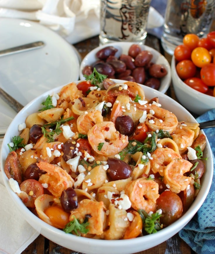  One Pot Mediterranean Shrimp Pasta is an easy one pot meal mixing shrimp with your favorite Mediterranean ingredients, pasta and a creamy roasted red pepper sauce. Shrimp pairs nicely with the fresh tomatoes, artichokes, kalamata olives, spinach and is topped with a creamy roasted red pepper sauce.  