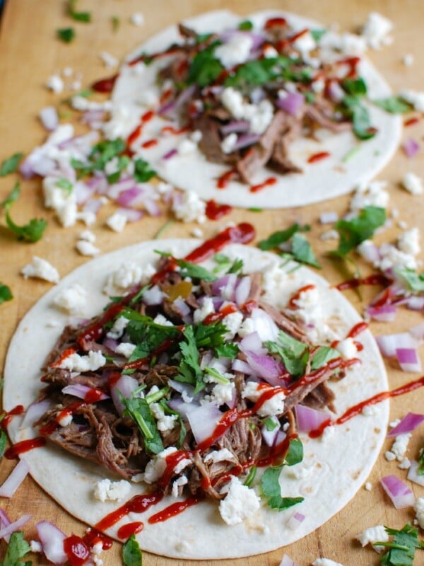 Juicy, tender and flavor packed Slow Cooker Beef Barbacoa makes the perfect pairing for rice bowls, filling for tacos or quesadillas or a topping for a salad. Beef is cooking in warm, rich sauce made using chipotle chilis, diced chilis, cumin, Mexican oregano, cinnamon, cloves and lime juice creating delicious shredded beef. 