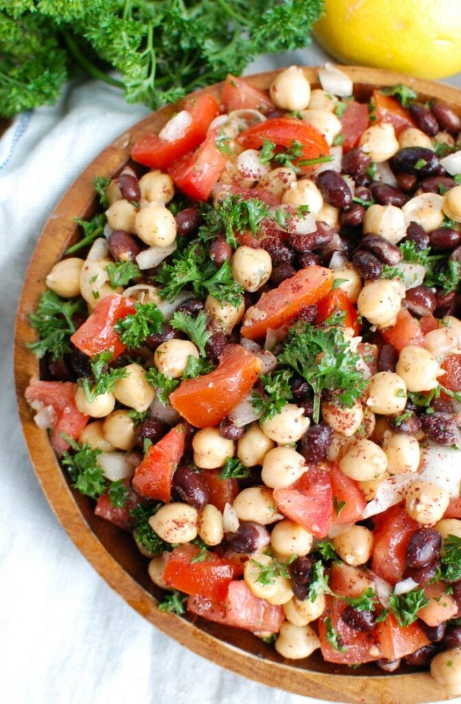 Balela Salad is a light and healthy salad mixing chickpeas, black beans, tomatoes, onion and parsley topped with a lemony sumac dressing with a hint of spice. This works great as lunch, as a side to dinner or topping to your pita, rice bowls or alongside grilled chicken or seafood.