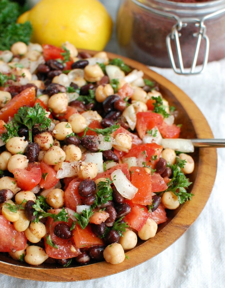 Balela Salad is a light and healthy salad mixing chickpeas, black beans, tomatoes, onion and parsley topped with a lemony sumac dressing with a hint of spice. This works great as lunch, as a side to dinner or topping to your pita, rice bowls or alongside grilled chicken or seafood.