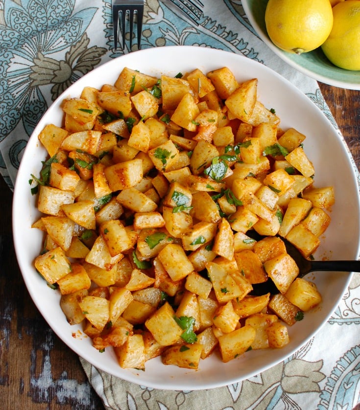 Spicy Lebanese Potatoes are crisp on the outside, tender on the inside and will spice up any meal. The sauce on these potatoes is the star featuring coriander, paprika, cayenne pepper mixed with olive oil and lemon juice. The dish is finished off with your favorite herb, cilantro or parsley. 