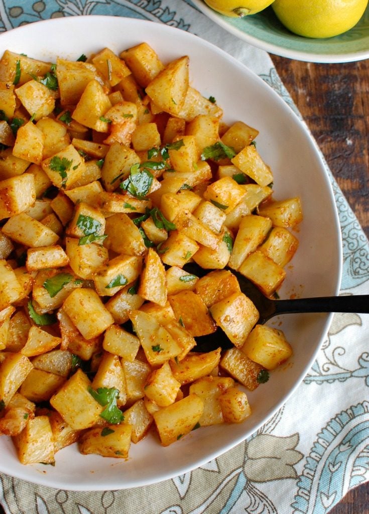 Spicy Lebanese Potatoes are crisp on the outside, tender on the inside and will spice up any meal. The sauce on these potatoes is the star featuring coriander, paprika, cayenne pepper mixed with olive oil and lemon juice. The dish is finished off with your favorite herb, cilantro or parsley. 