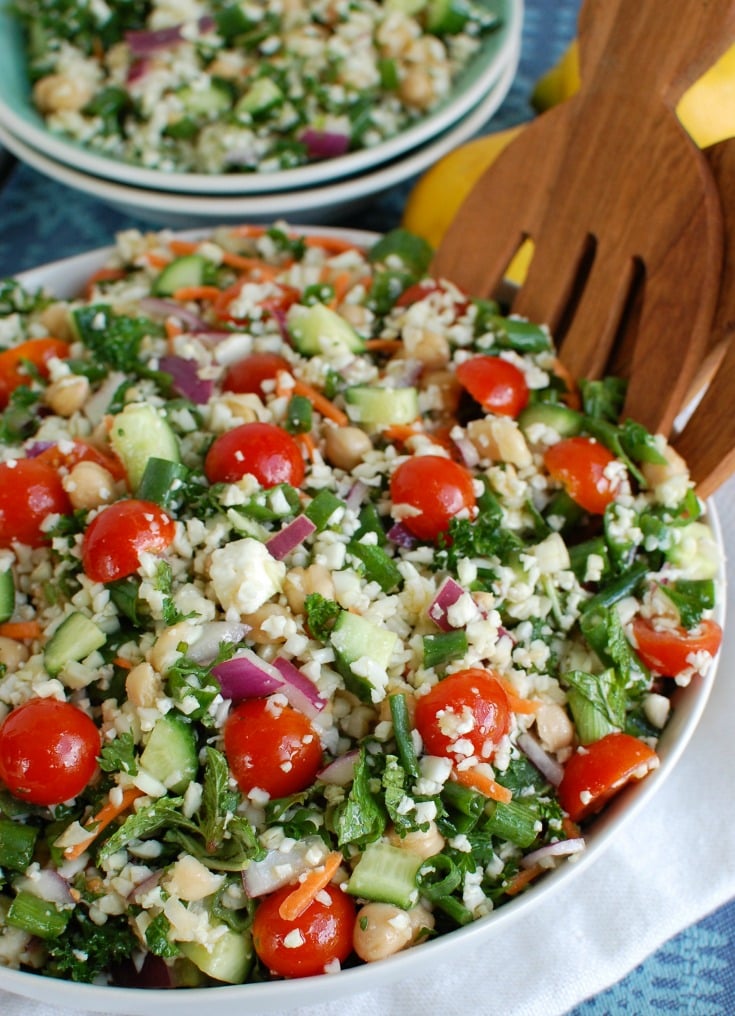 Mediterranean Chickpea Cauliflower Salad with tongs.