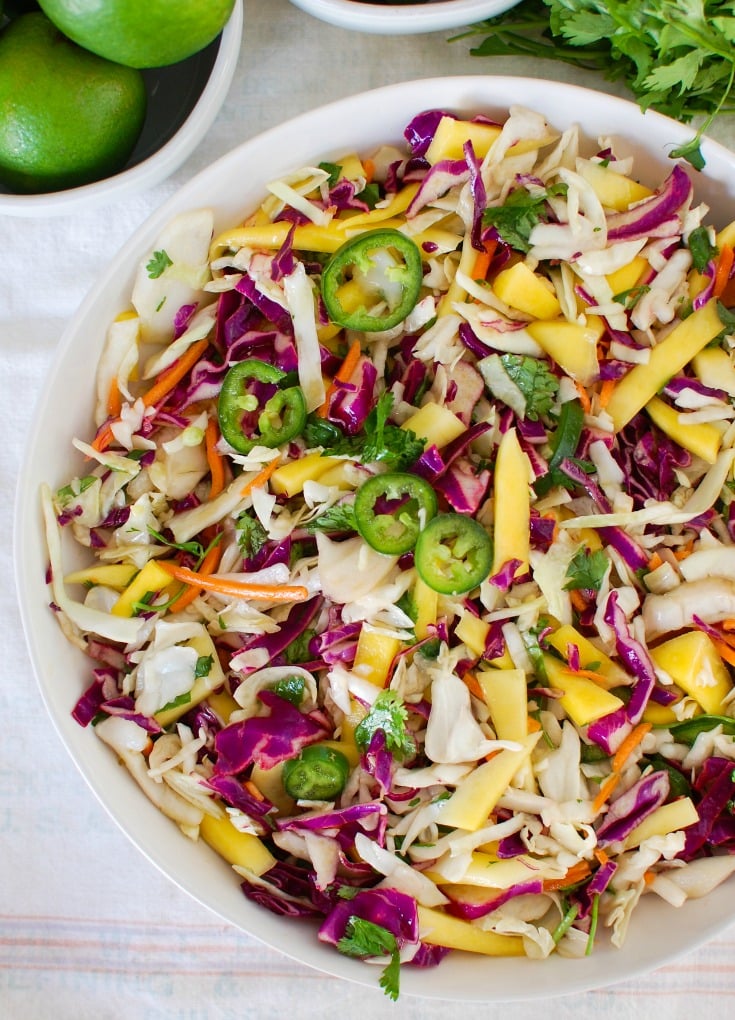 Easy Mango Cabbage Coleslaw in a white bowl.