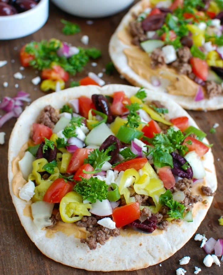 Greek Beef Pita Pizza on cutting board 
