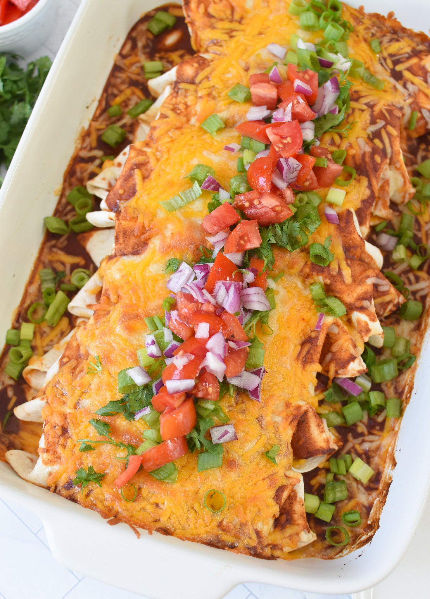 Beef Enchiladas with garnishes. 