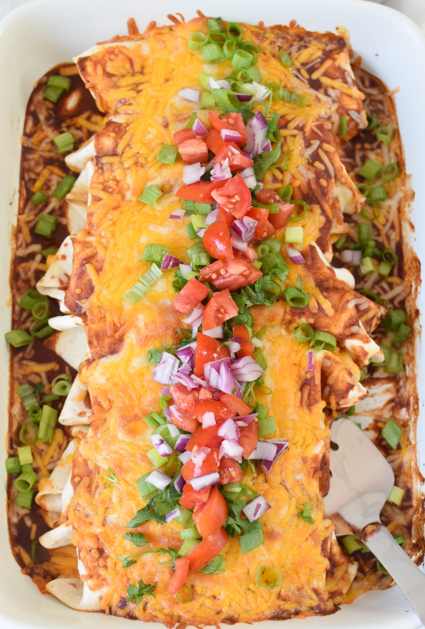 Beef Enchiladas with a spatula. 