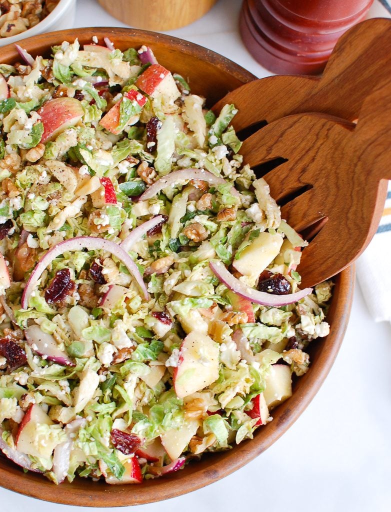 Brussels Sprout Apple Goat Cheese Salad with Wooden Tongs