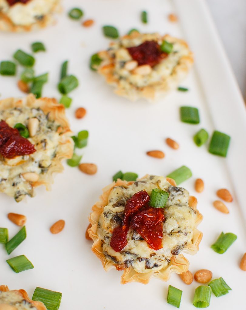 Spinach Artichoke Sun-dried Tomato Phyllo Bites on White Plate 
