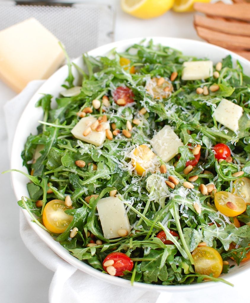 Lemon Arugula Salad with Pine Nuts with Wood Tongs 
