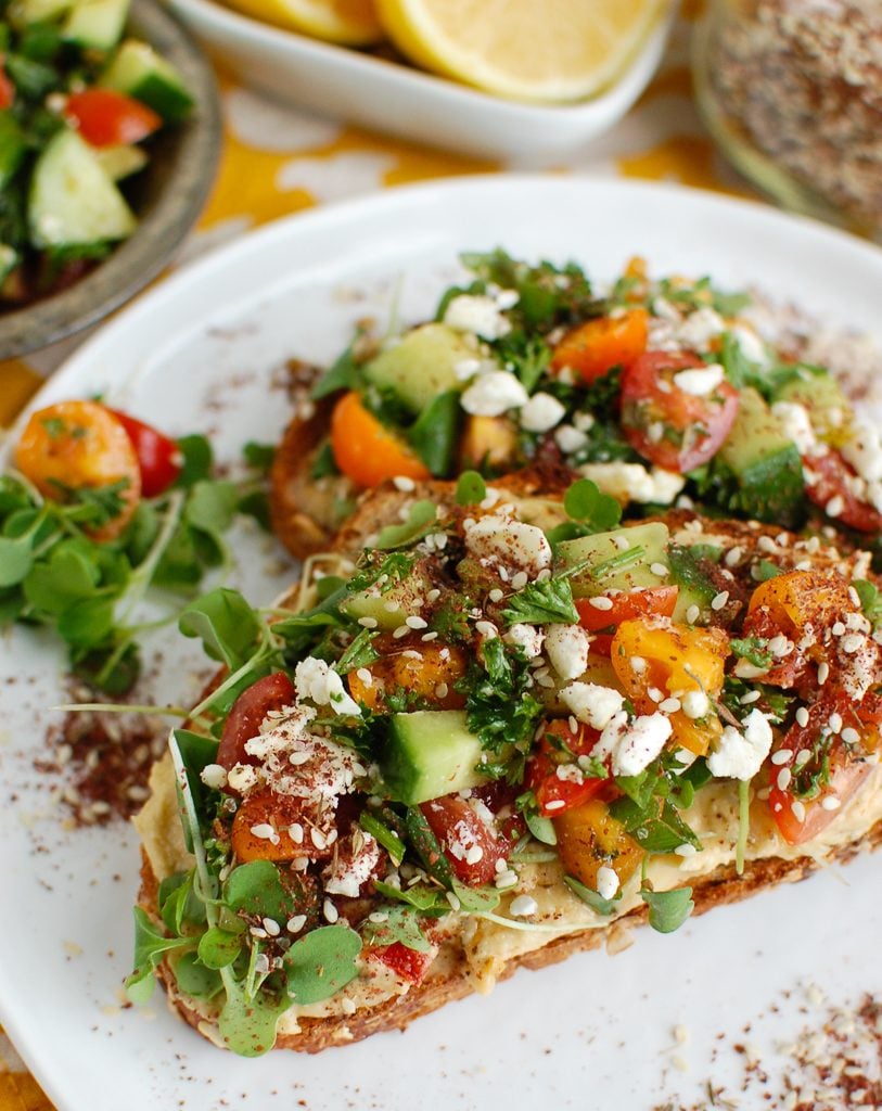 Mediterranean Hummus Toast with Za'atar on White Plate 