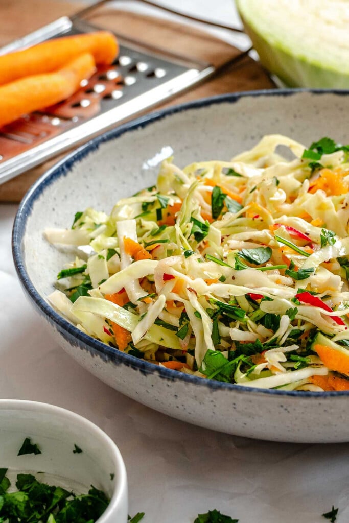 Healthy Coleslaw in blue rimmed bowl 
