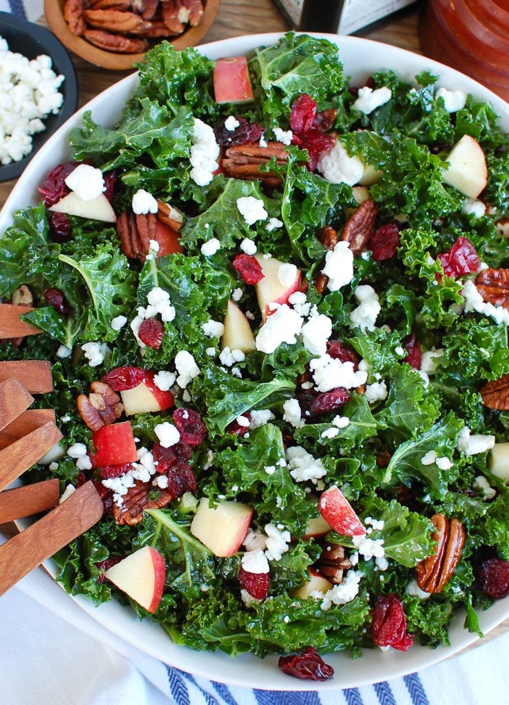 Kale Salad with Cranberries with Wooden Tongs 