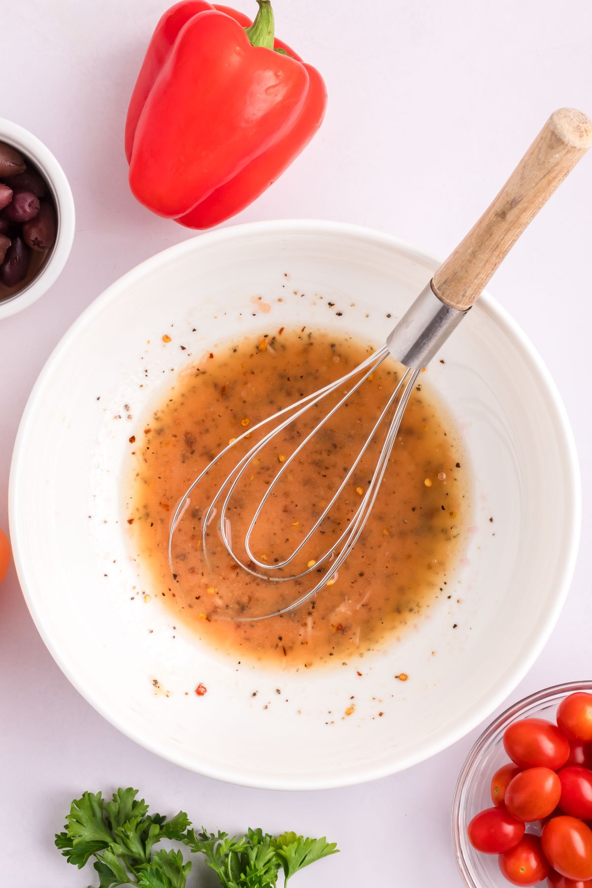 Mediterranean Chickpea Salad with dressing in a bowl.
