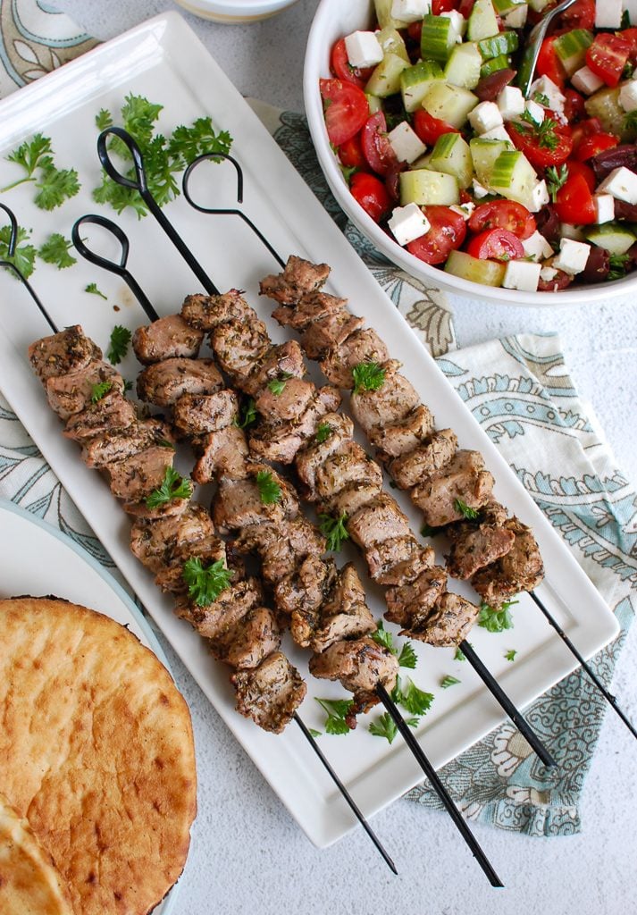 Pork Souvlaki with Tzatziki on white platter 