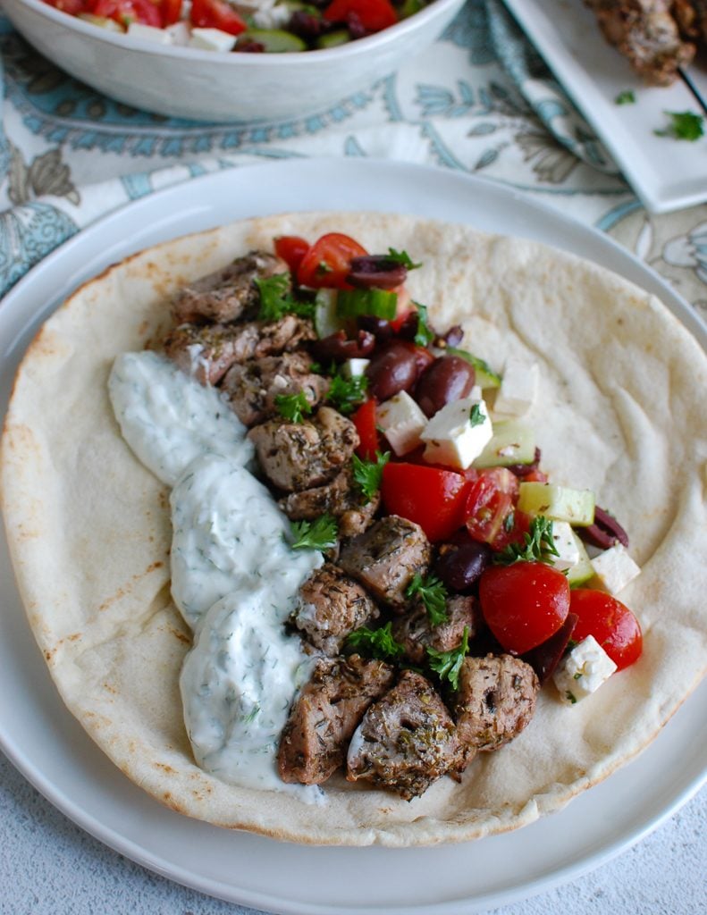 Pork Souvlaki with Tzatziki on a white pita 