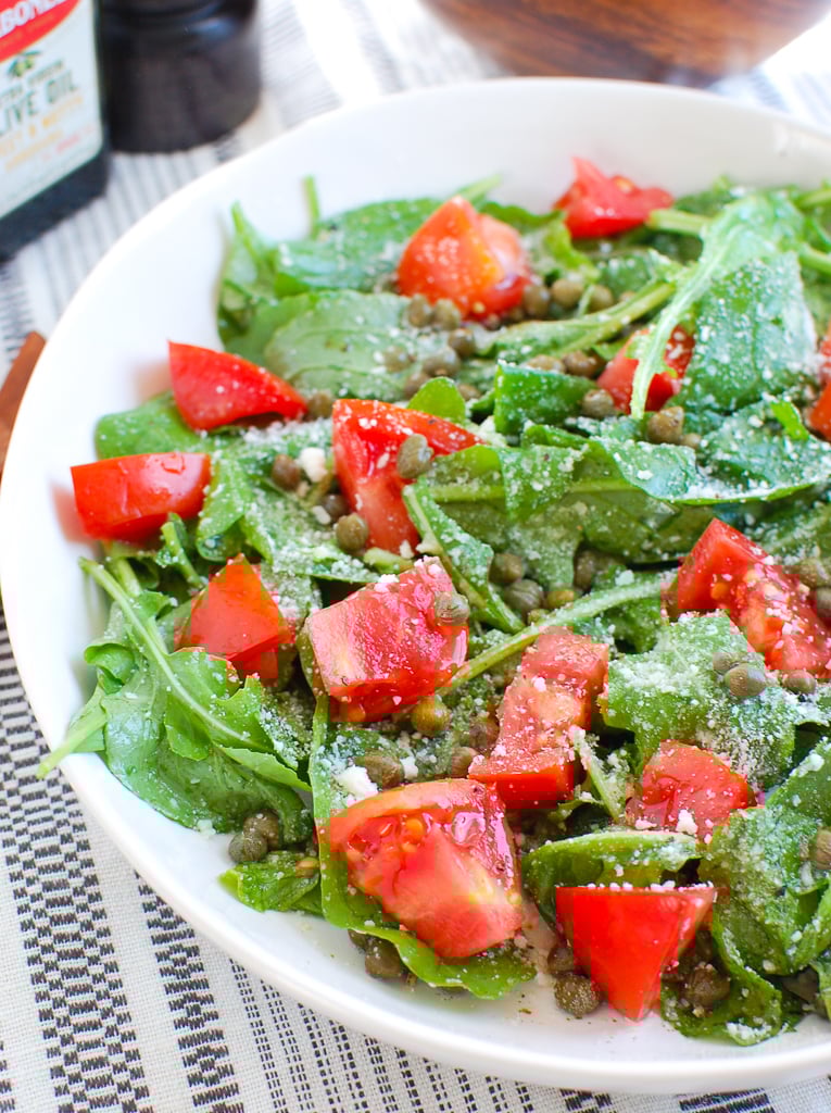 Arugula Salad with Capers in white bowl 