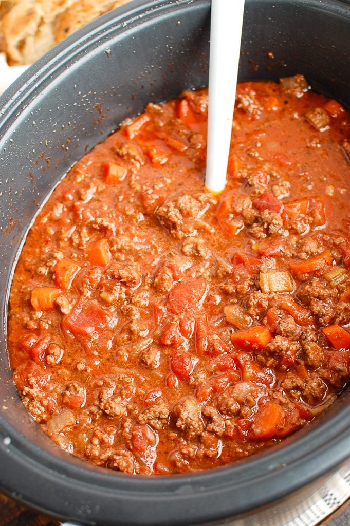 Slow Cooker Spaghetti Sauce with a white spoon