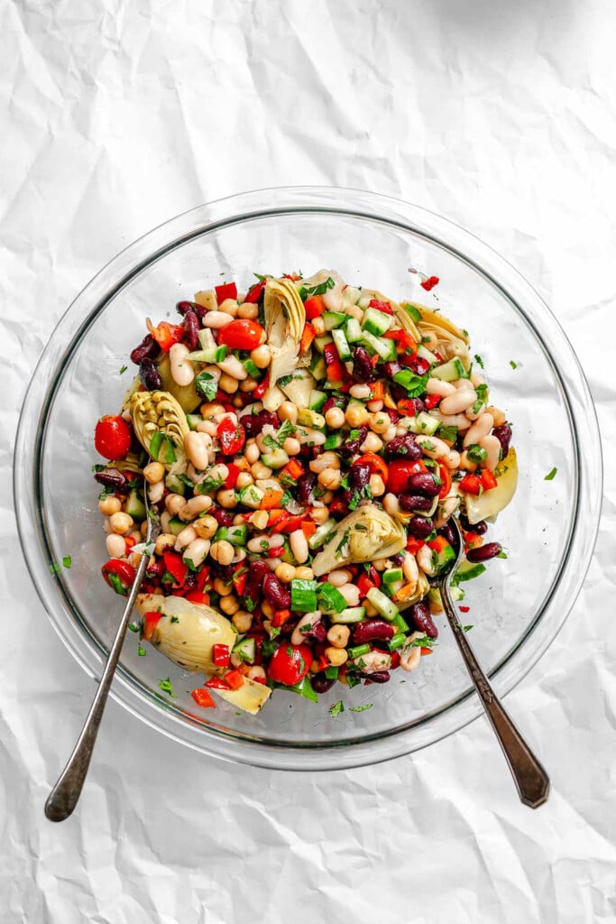 Mediterranean Three Bean Salad in a bowl with two spoons 